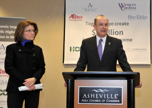 UNCA Chancellor Mary Grant  and WCU Chancellor David Belcher, as he  speaks on higher education impact on state's economy. 