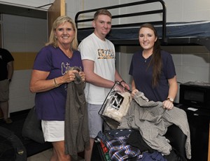 From left, Deannie Starnes and her son, Carter, and daughter, Allie, begin unpacking Carter’s belongings in his room at Scott Residence Hall. Photo courtesy of WCU Office of Public Relations. 