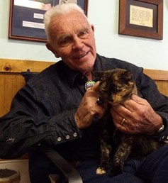 Harold “Catman” Sims, owner of Catman2, loves on a kitty. Photo via catman2.org
