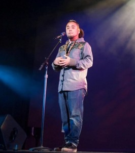 G Yamazawa performs slam poetry on stage. Photo via GYamazawa.com.
