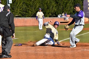 Bryson Bowman slides into home plate. Photo by Becca Ross.