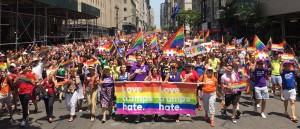 LGBT activists join together to march with the slogan of "Love Trumps Hate" and signs in support of Clinton. Photo courtesy of Clinton's campaign website.