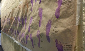 Students have made a mural by sticking their feet in paint and writing about what Samaritan's Feet means to them, Oct. 24, 2016. Photo by Austin McDowell