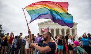 As the crowd outside of the Supreme Court chanted, "Love Has Won," in June of 2015, supporter Vin Testa celebrated with the waving of a rainbow flag. Photo courtesy of the New York Times